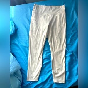 Shimmering white capri Fabletics leggings.